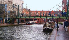 The Birmingham Canal Navigations Main Line Canal between the International Convention Centre (left), Brindleyplace (right), and Broad Street Tunnel (ahead) in central Birmingham, England. A part of the canal originally called Deep Cutting.